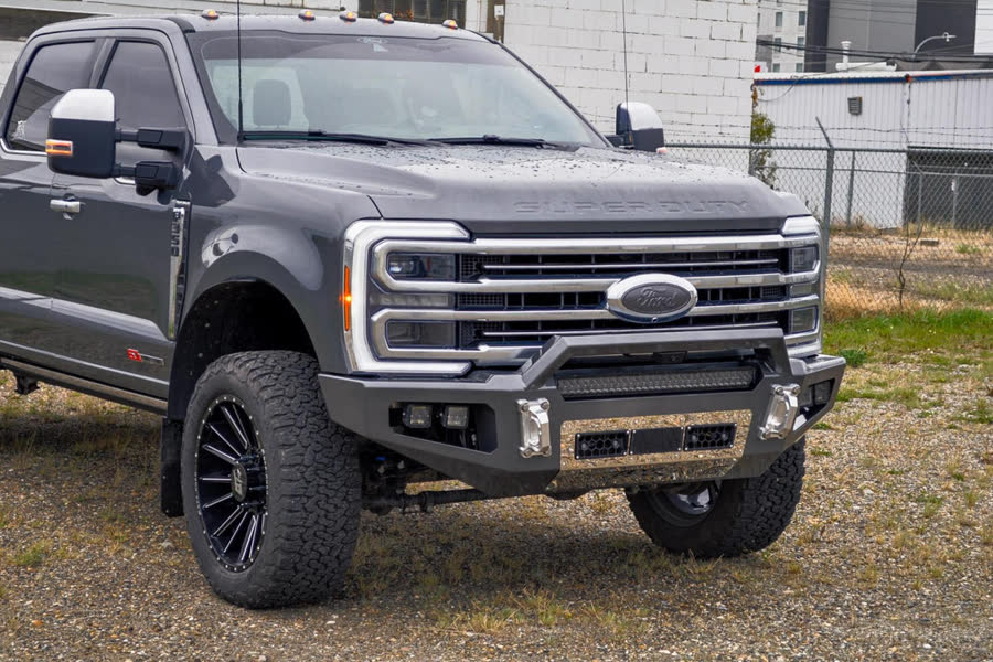 Grey Ford Super Duty with a Gridiron Prerunner front bumper and LED light bar